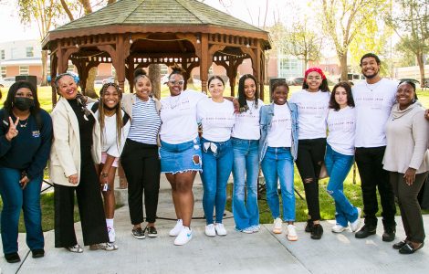 Photo of Lorri Santamaría with students at a Black History Month kickoff event.